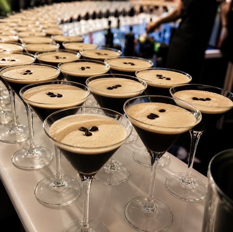 Rows of espresso martinis lined up on a bar
