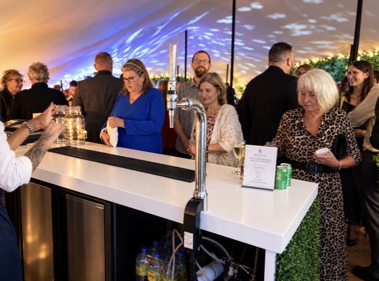 Rudd Catering team serving guests from a mobile bar during an evening reception