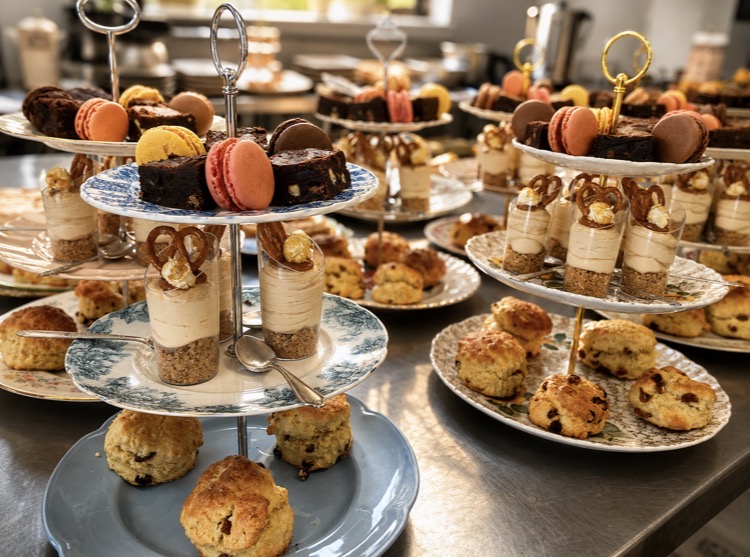 Afternoon tea stands with scones, macarons, homemade cakes and desserts
