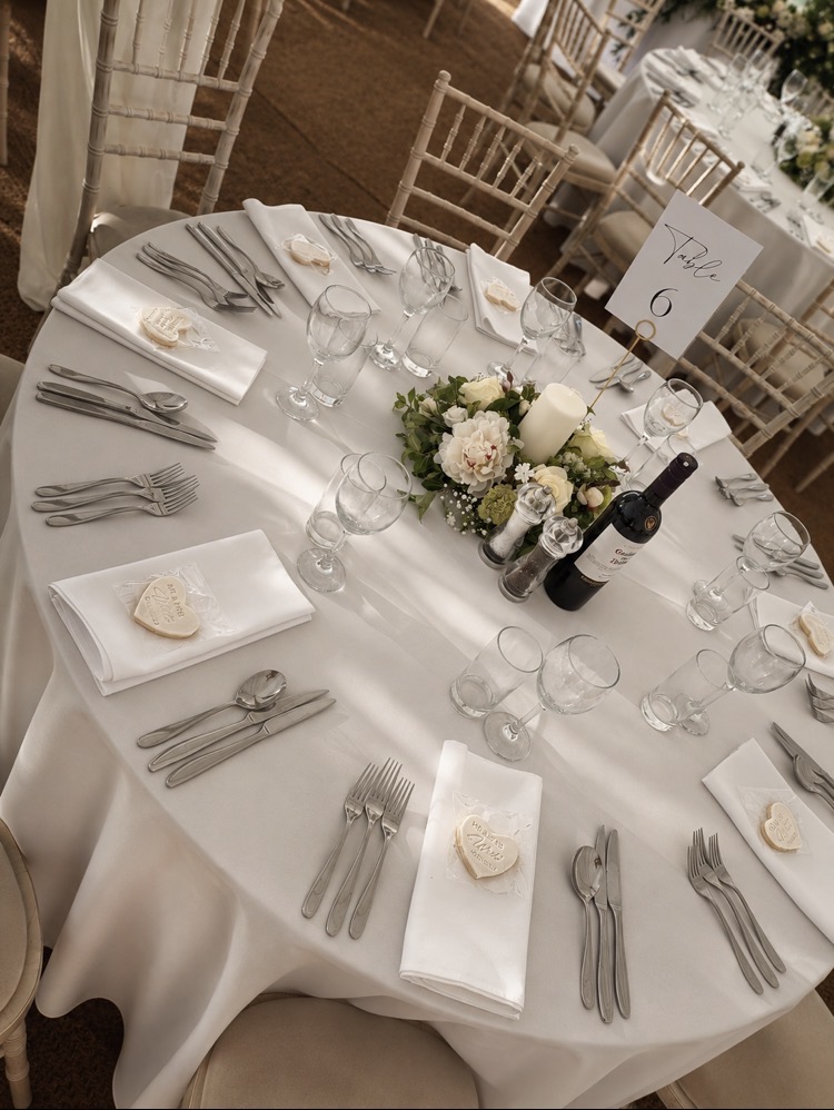 Round wedding table laid for a barn wedding breakfast in Norfolk