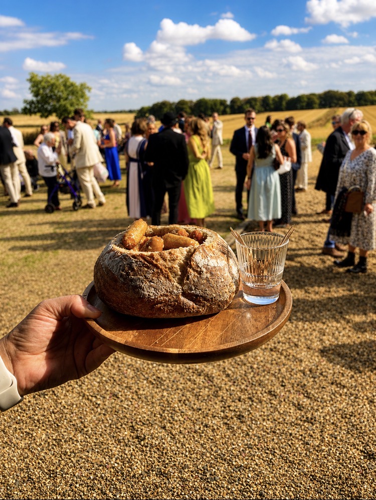 Honey chipolatas in a sourdough loaf served to guests at a field drinks reception