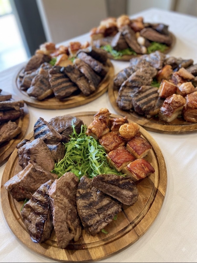 Roast beef and pork belly sharing platters carved and served on wooden boards