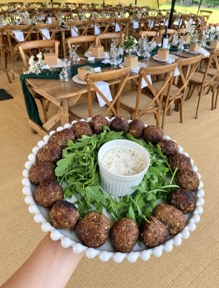 Falafel sharing platter with rocket and herb yoghurt on a dressed wedding table