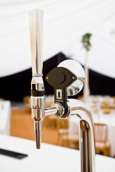 Chrome beer tap at a Rudd Catering mobile bar inside a white marquee