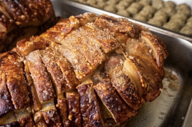 Slow-roasted hog roast with golden crackling, carved and ready to serve