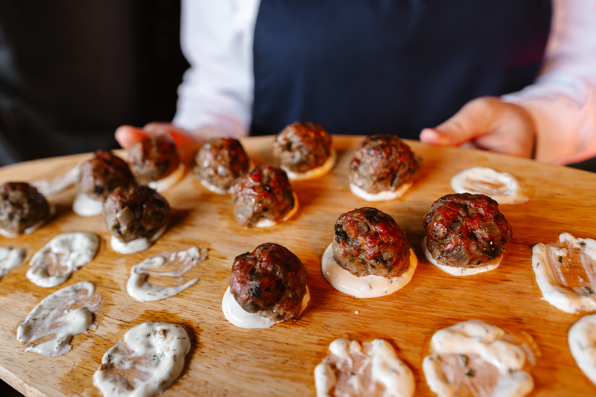 Chef finishing a dish with fresh herbs at a private party