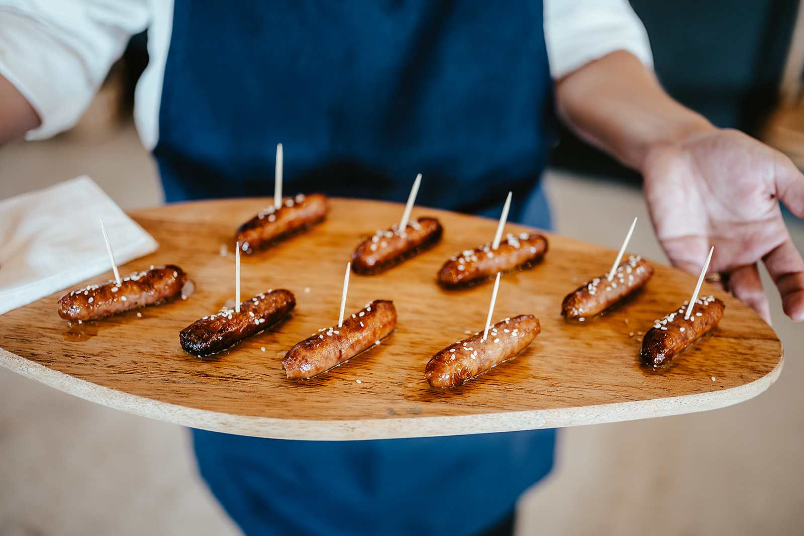 Sea-salted honey chipolatas served on a wooden board