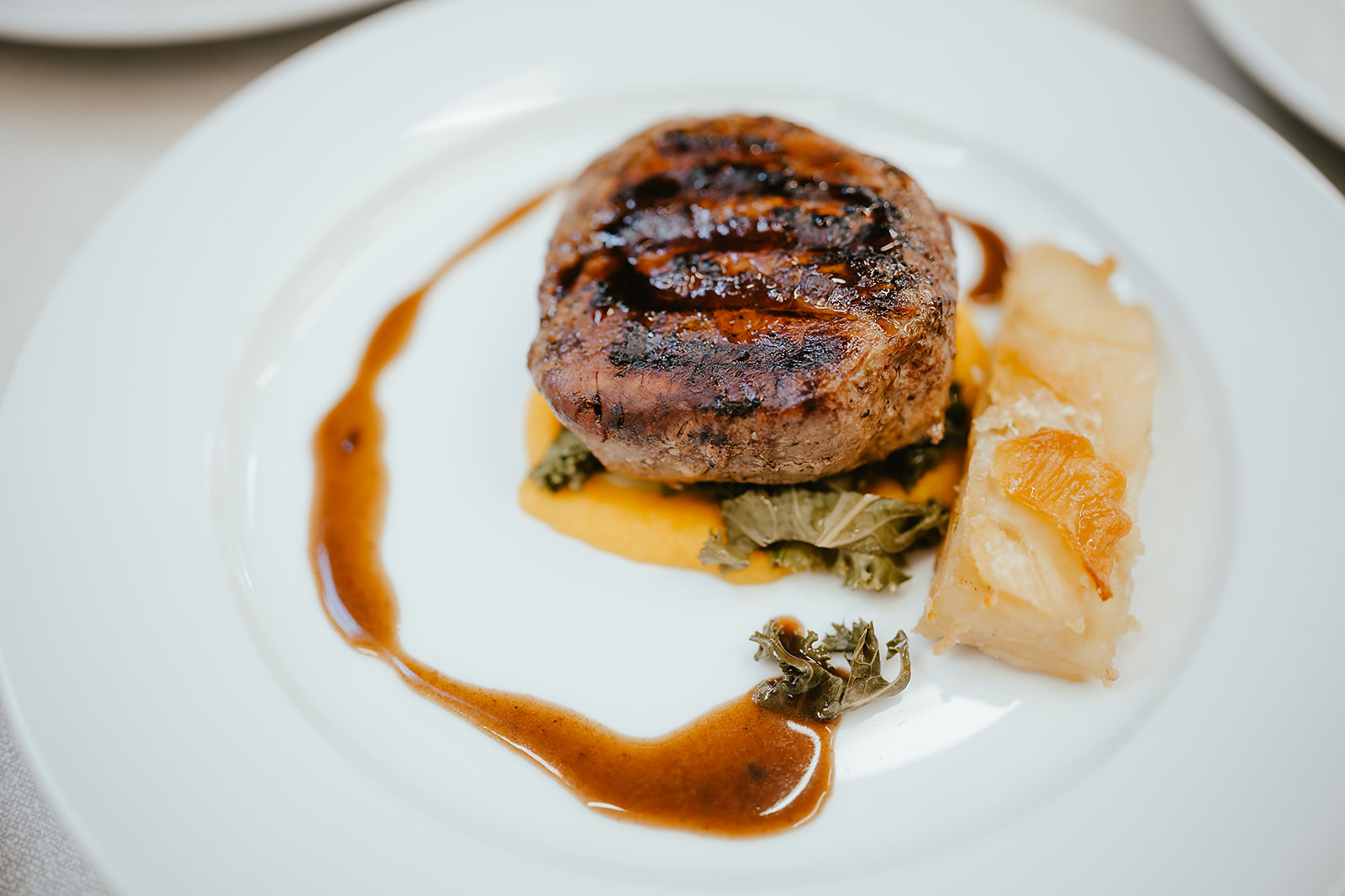 Chargrilled pork fillet with kale, squash purée and dauphinoise