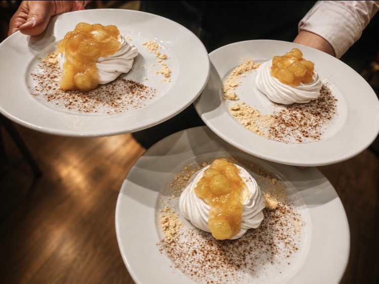 Dessert meringues with caramelised apple served for a private dinner party