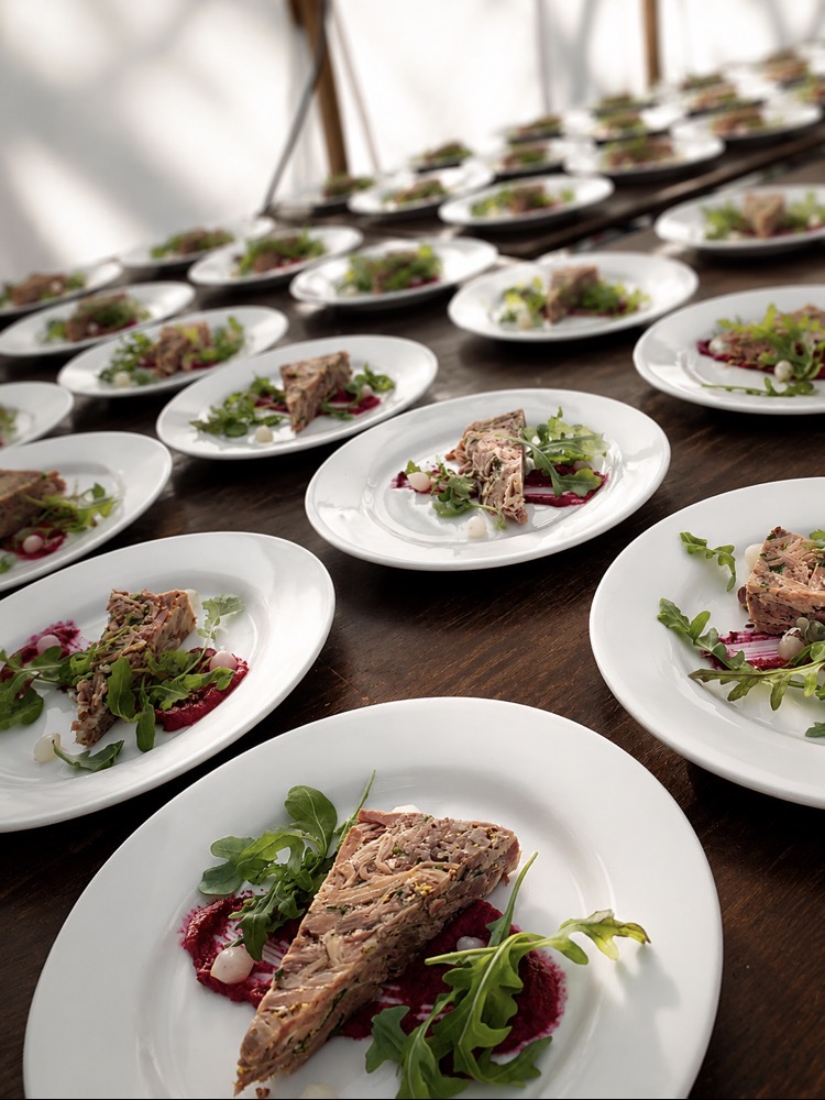 Line of plated starters prepared by Rudd Catering for a formal wedding dinner
